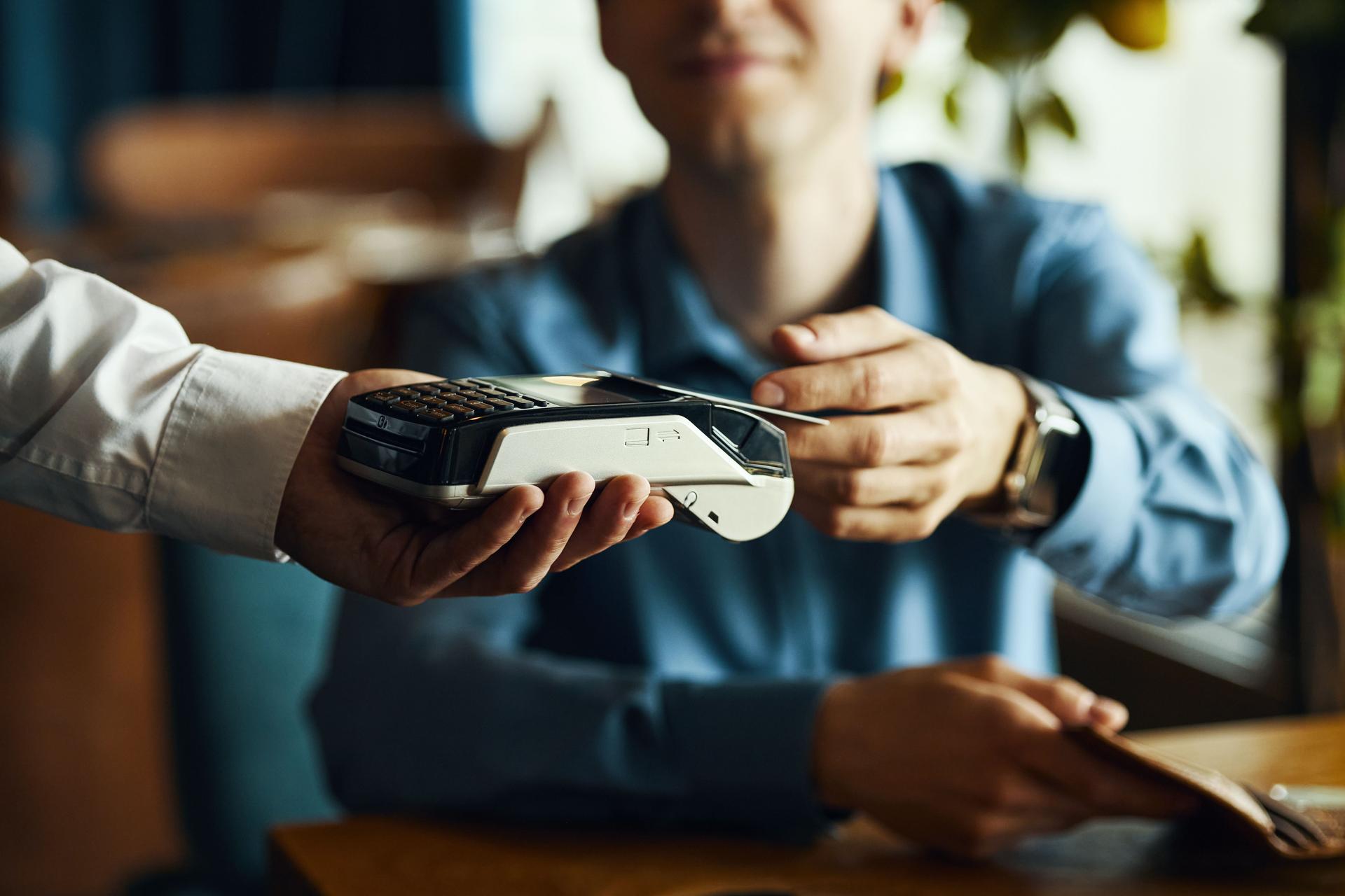 Caucasian Young Adult Man Making Contactless Payment Using Card Reader